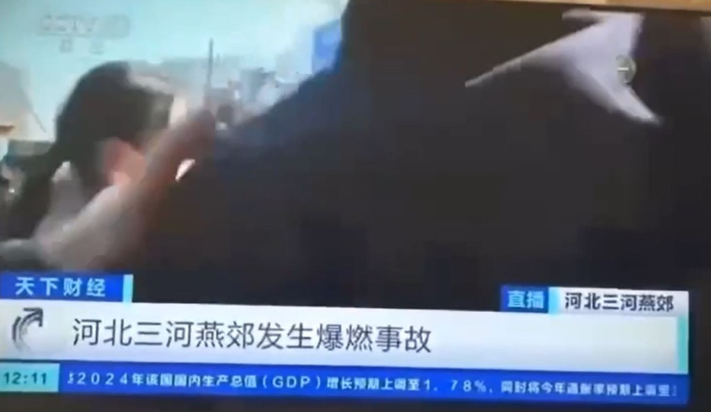 有制服人员故意阻挡镜头。(央视截图)